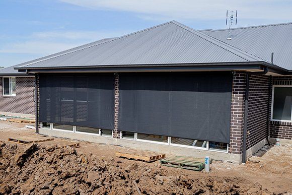 A House Is Being Built with A Lot of Dirt in Front of It — New Blinds and Shutters in Maryland, NSW