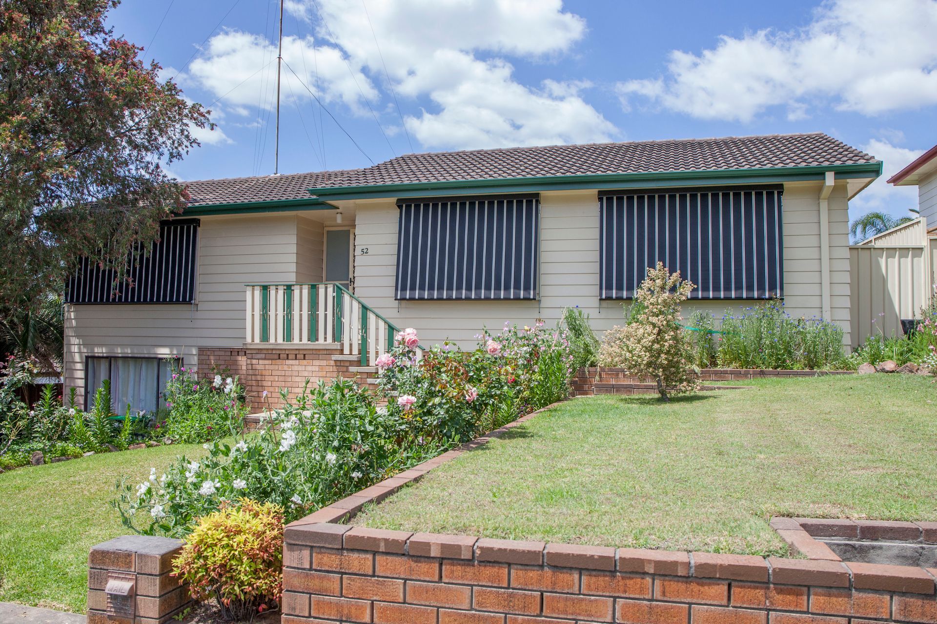A House with A Brick Wall in Front of It — New Blinds and Shutters in Maryland, NSW