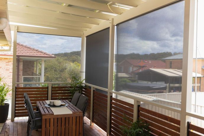 Black Blinds Surrounding Table and Chairs on a Patio	— New Blinds and Shutters in Maryland, NSW