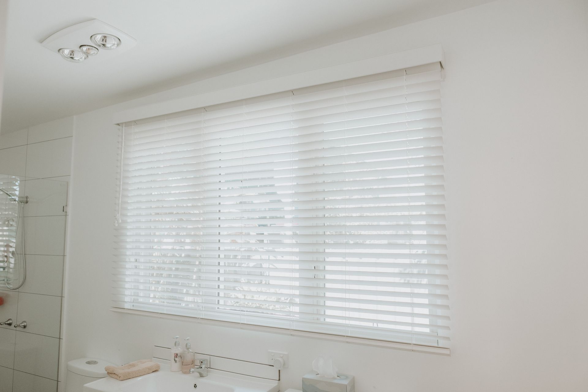 A Bathroom with A Sink and A Window with Blinds —  New Blinds and Shutter in Newcastle, NSW