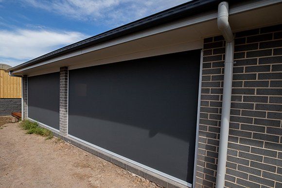 A House with A Lot of Windows and A Gutter on The Side of It — New Blinds and Shutters in Maryland, NSW