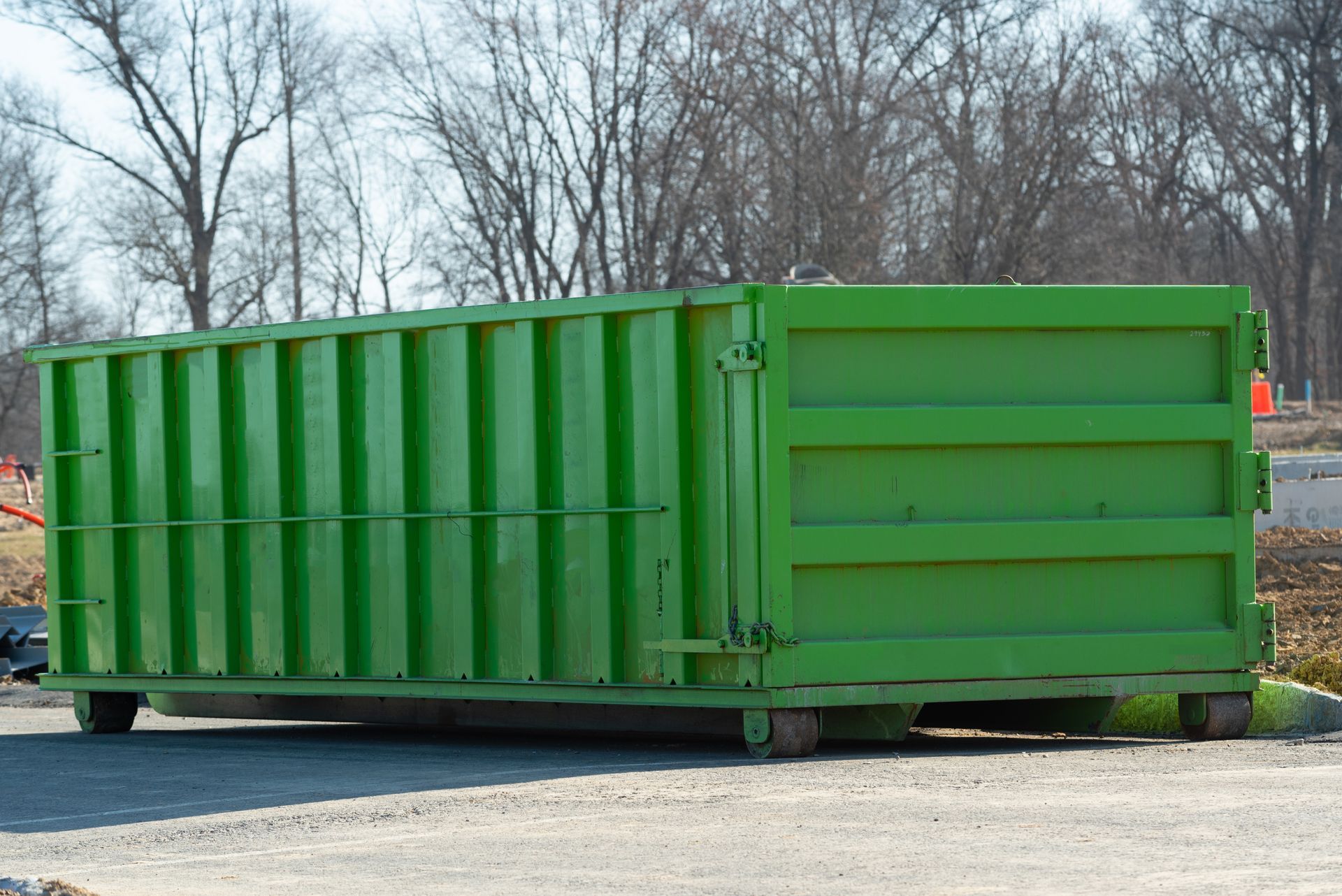 Green metal dumpster on wheels, outdoors. Green metal dumpster on wheels, outdoors.