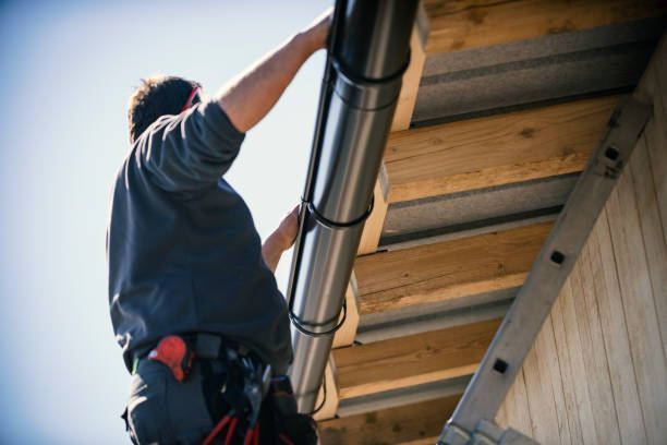 Technician doing gutter installation