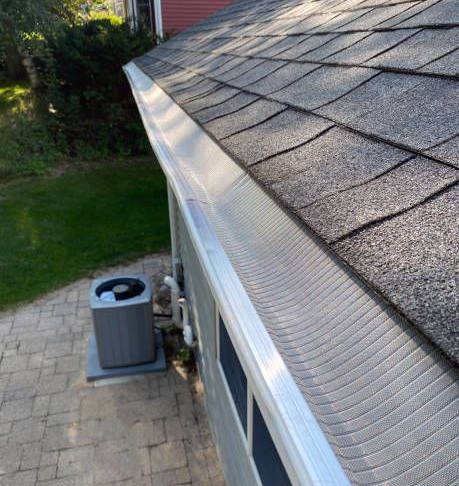 Clean aluminum gutter on shingle roof