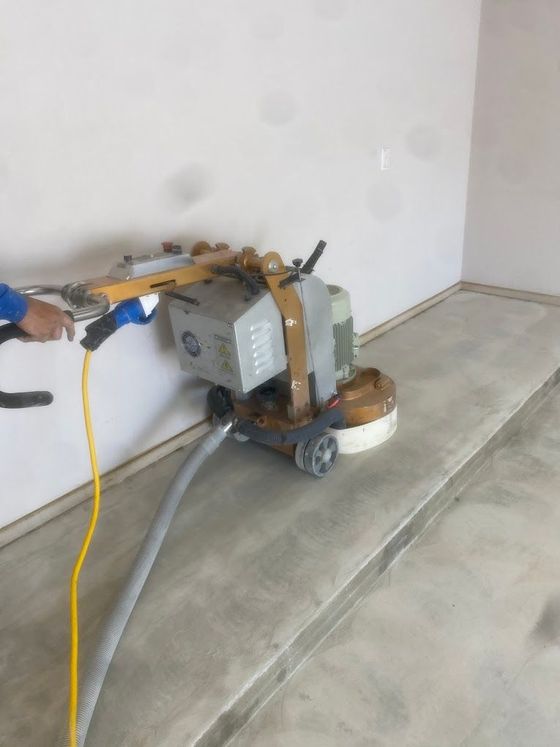 A person is using a machine on a concrete floor