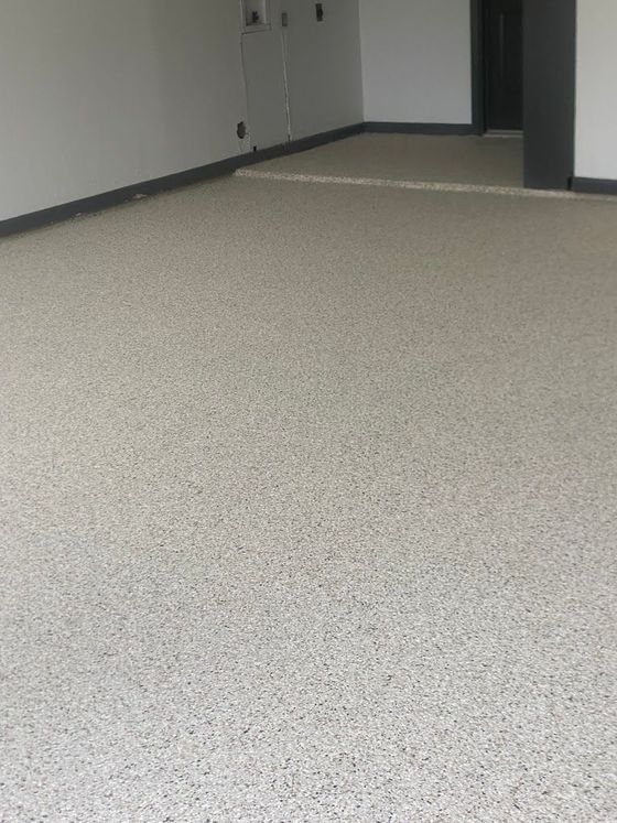 A room with a white carpeted floor and white walls.