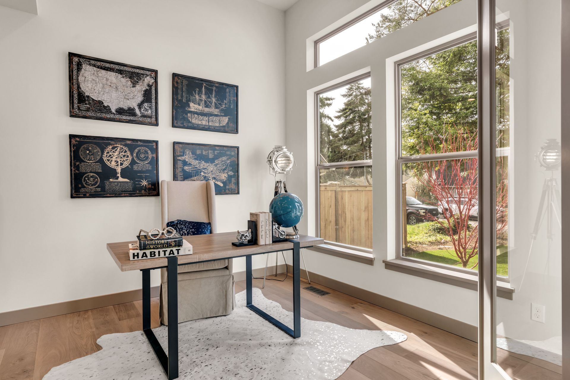 A beautiful home office with a desk , chair and a globe.