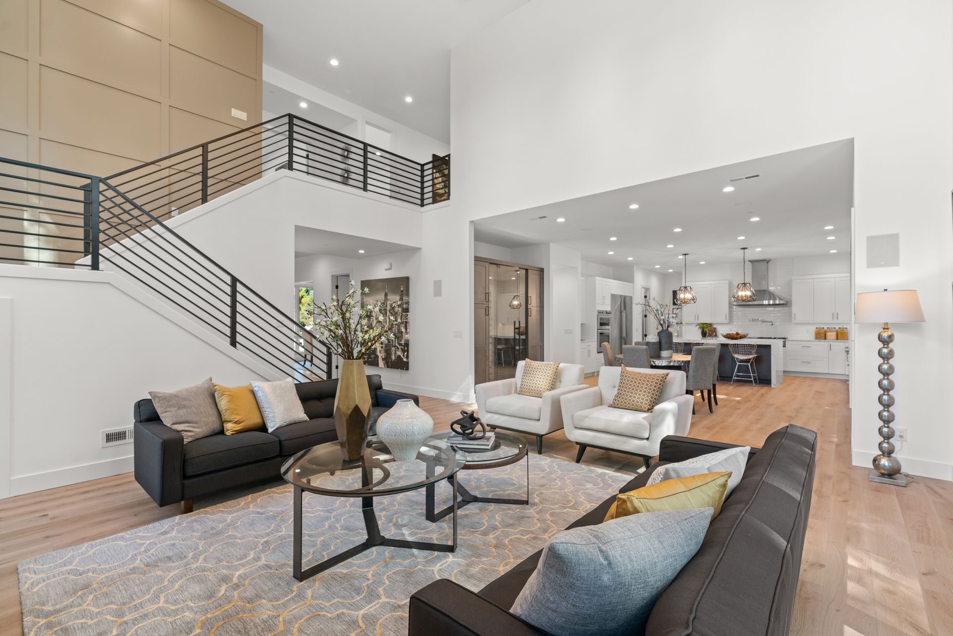 A living room filled with furniture and a staircase leading to the second floor.