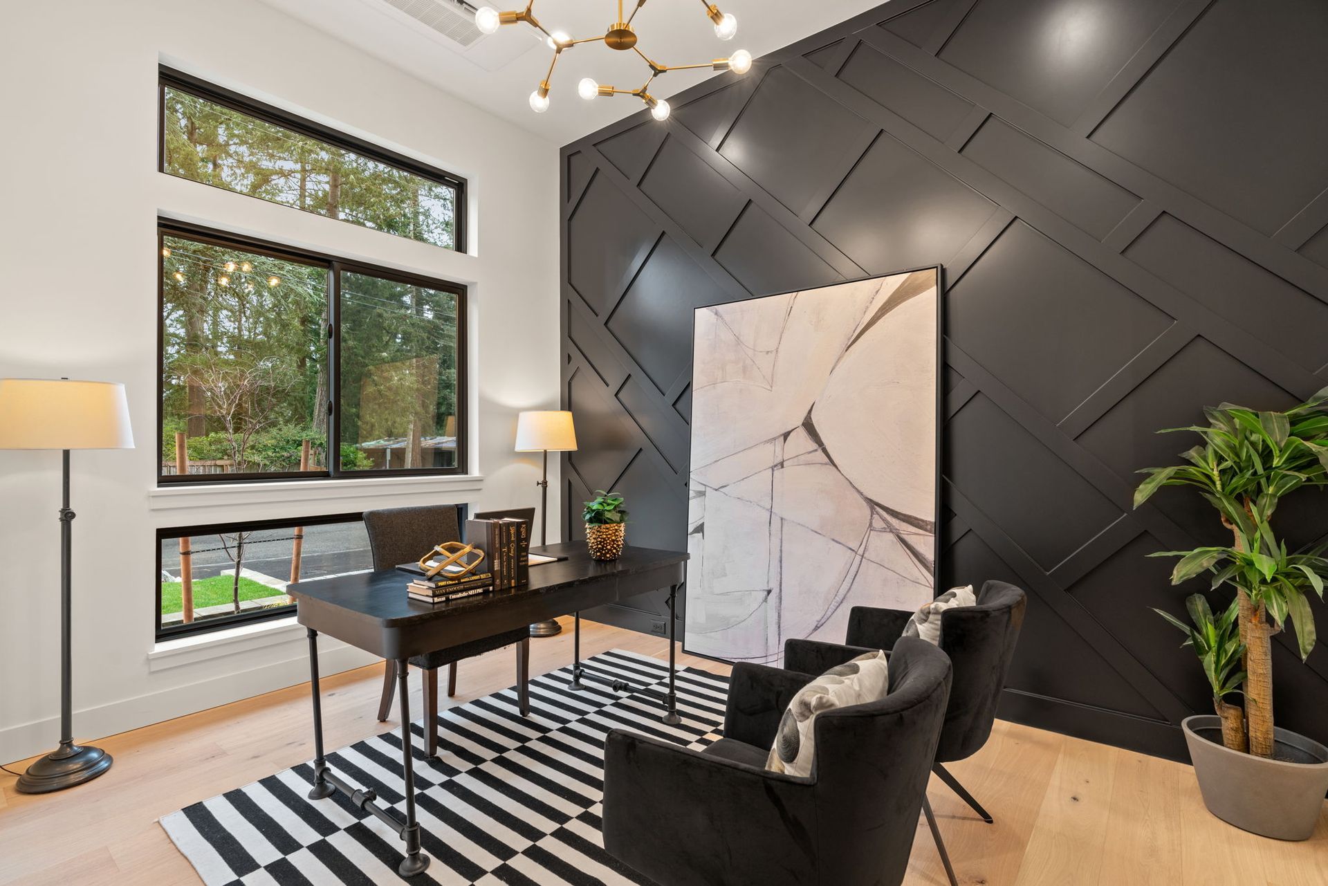 A home office with a desk, chairs, and a rug.