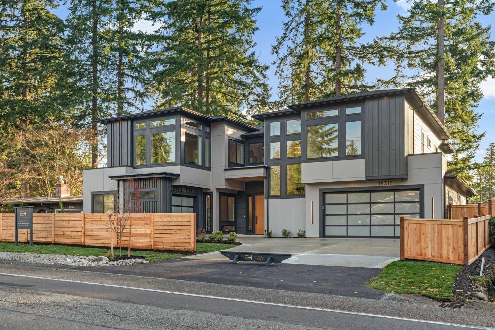 A modern house with a wooden fence in front of it