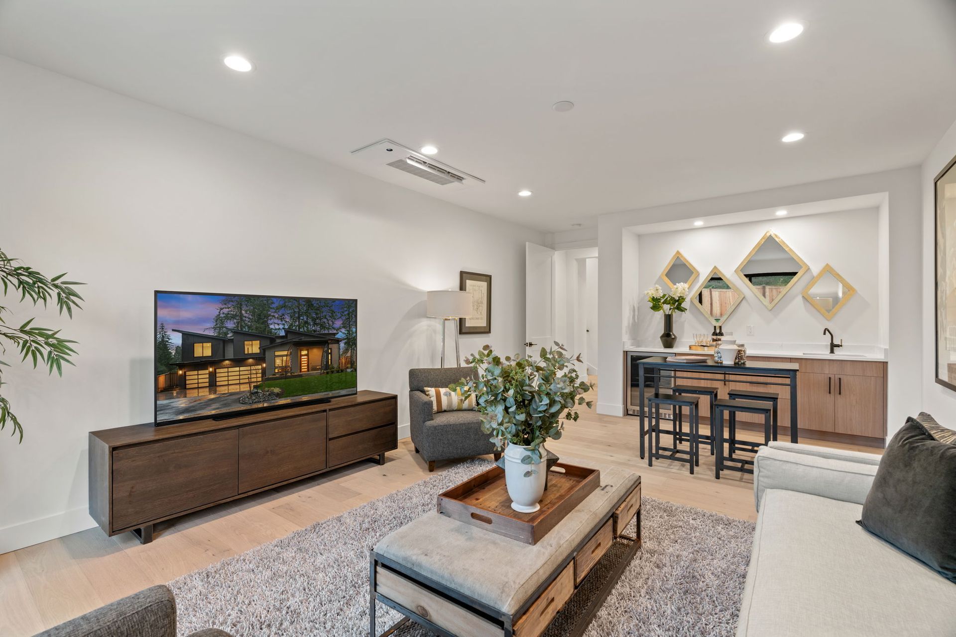 A living room with a couch, chair, coffee table and television.