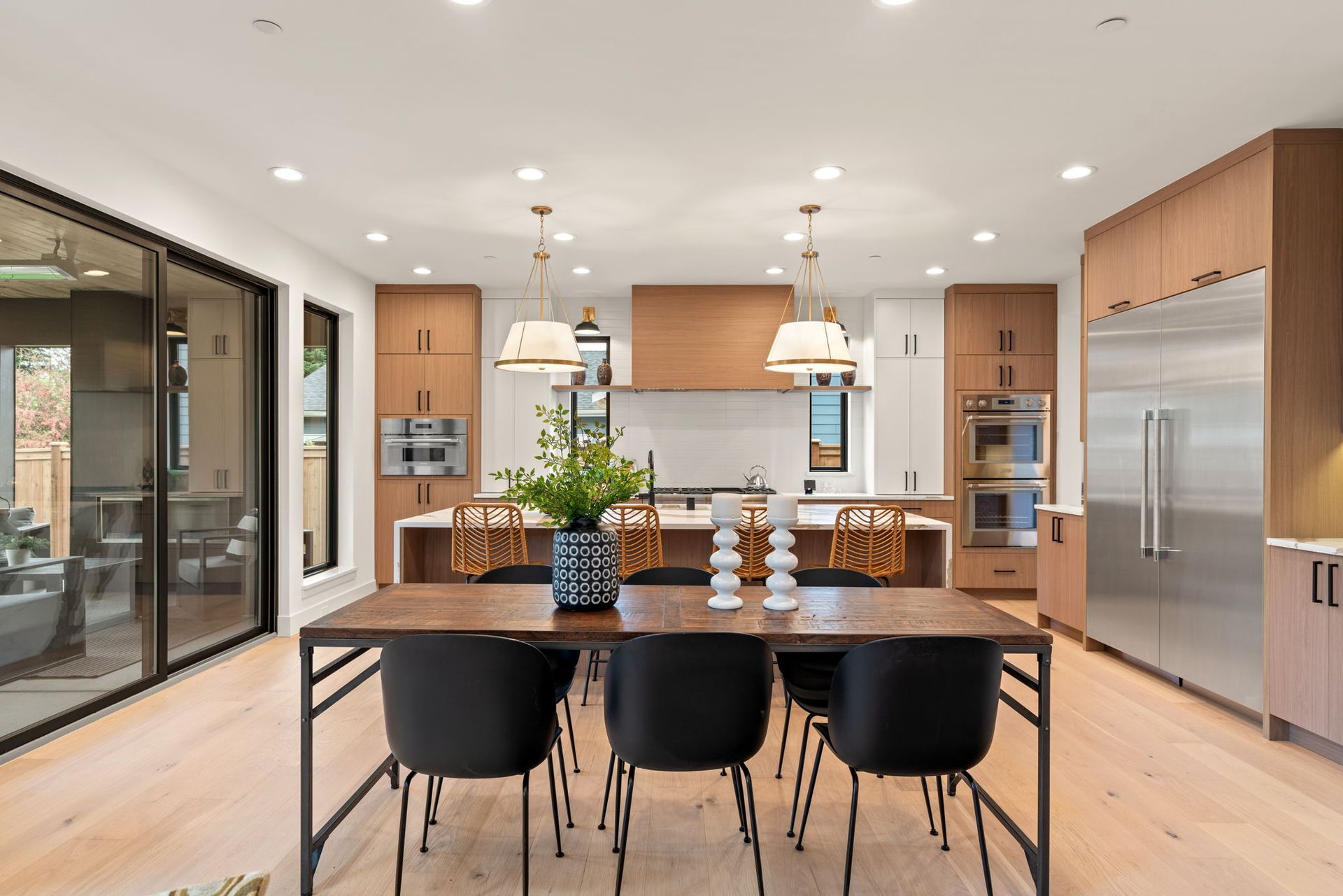 A kitchen with wooden cabinets, stainless steel appliances, a sink, a stove and a breakfast nook.