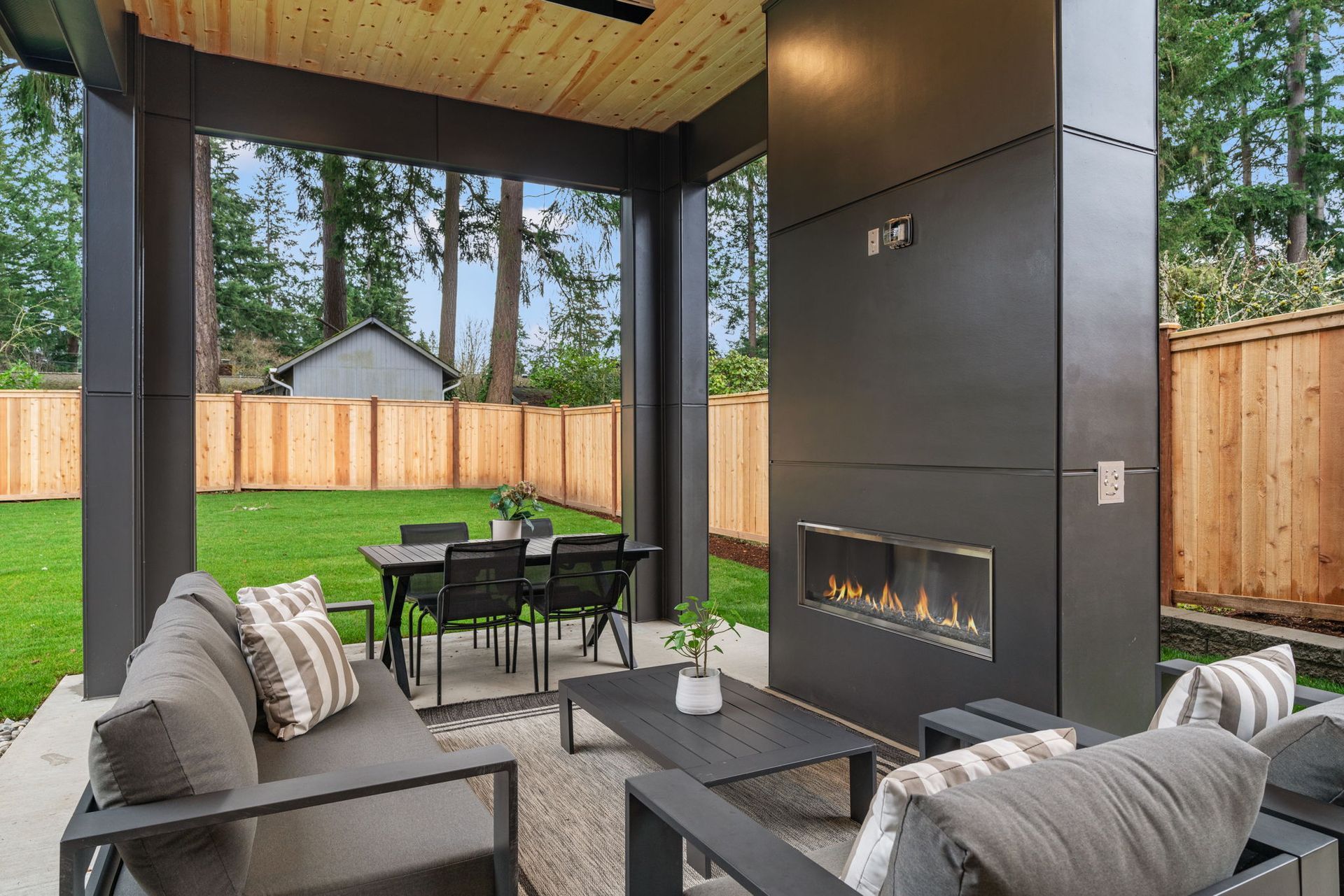 A patio with a fireplace and a table and chairs