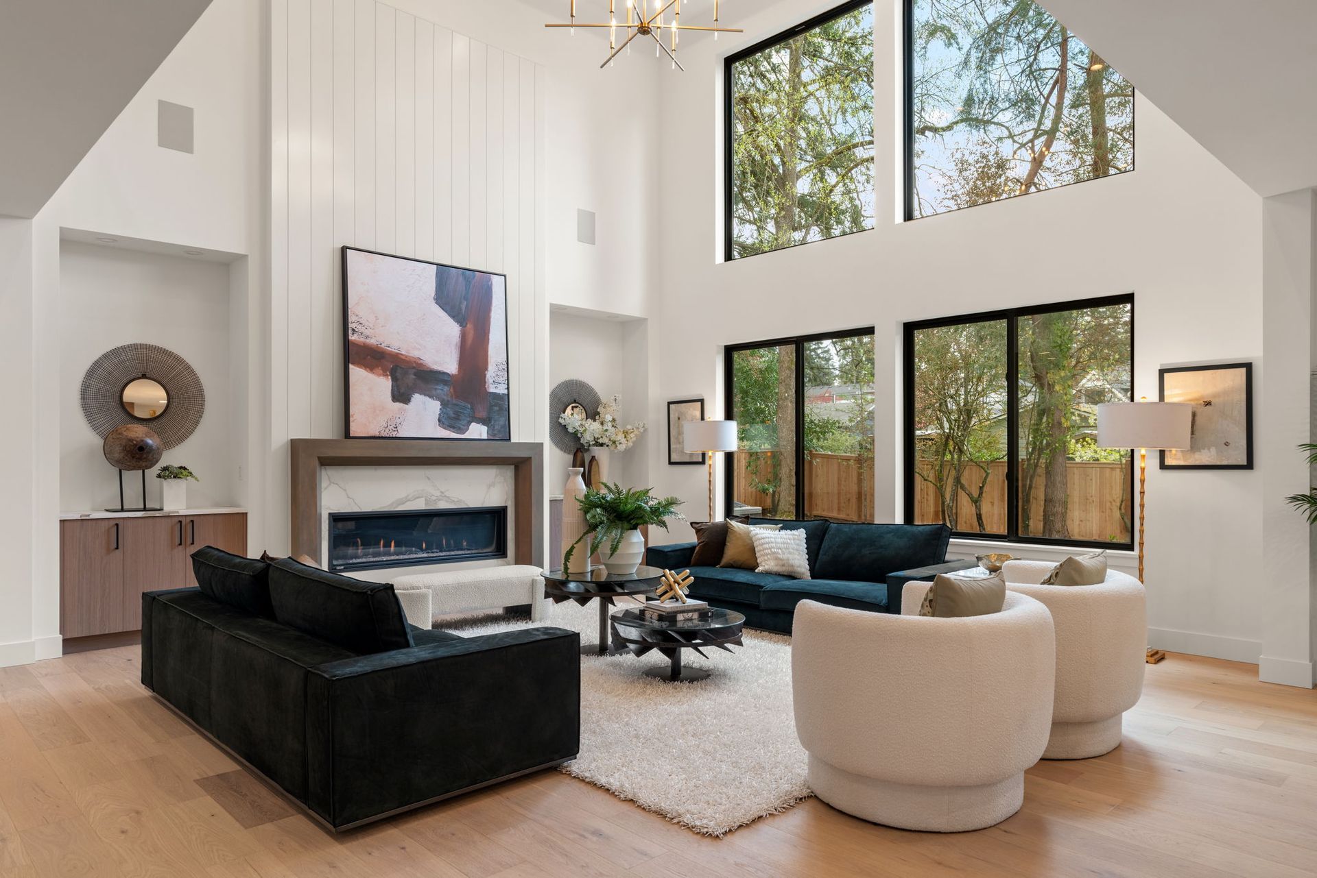 A spacious great room filled with furniture and a fireplace.