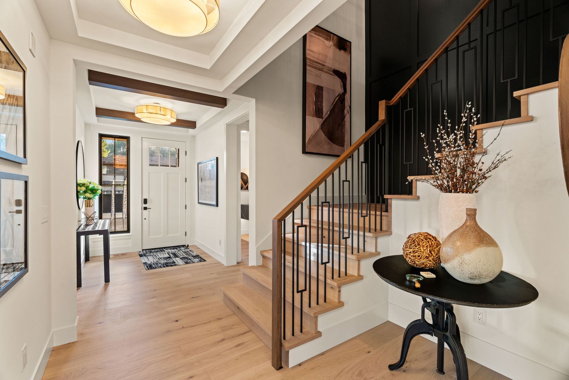 Living room with sofas, fireplace, and windows. Neutral colors, modern design, and natural light.