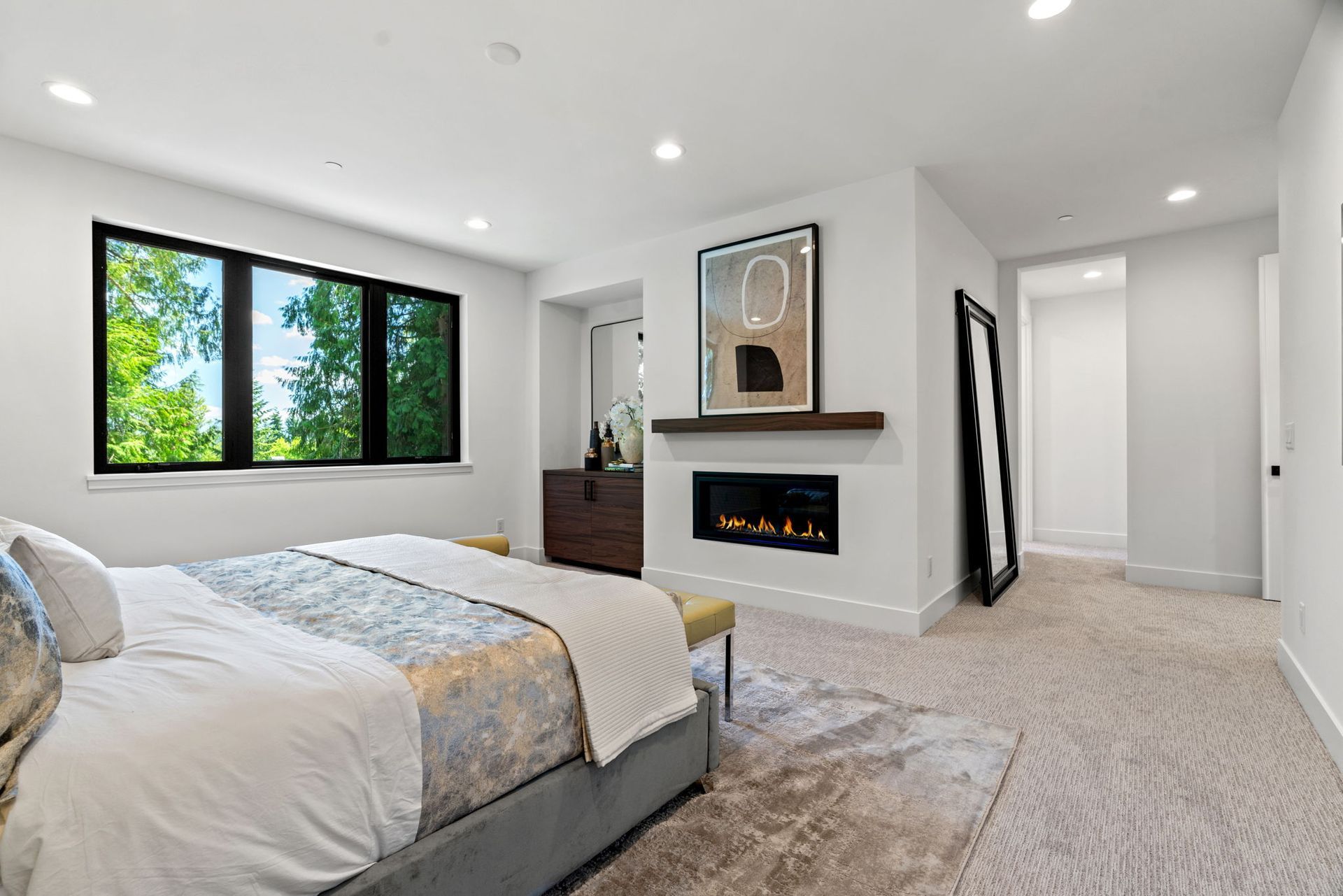 A bedroom with a fireplace and a large bed.