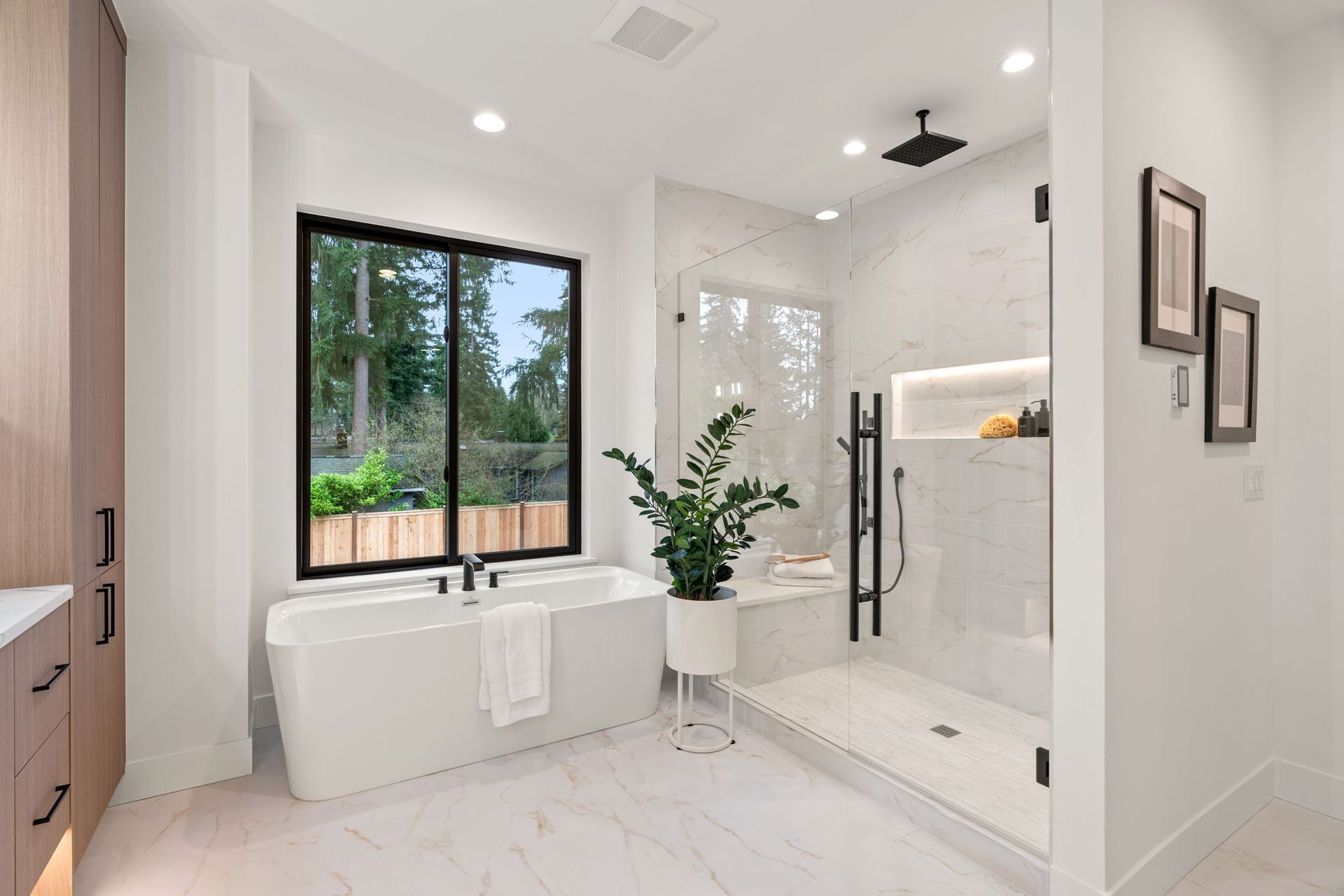 A bathroom with a tub, shower, and window.