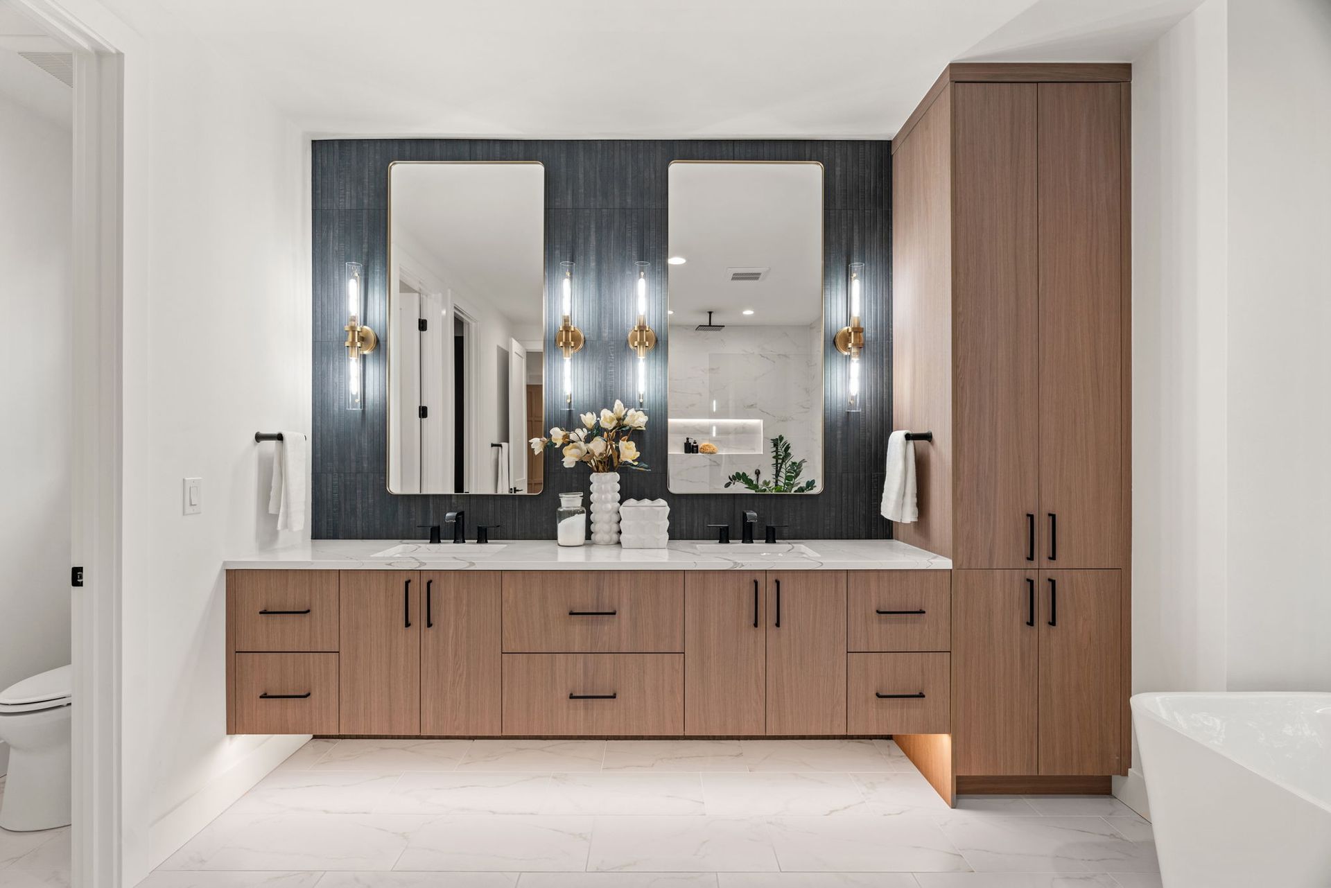 A bathroom with two sinks and two mirrors.