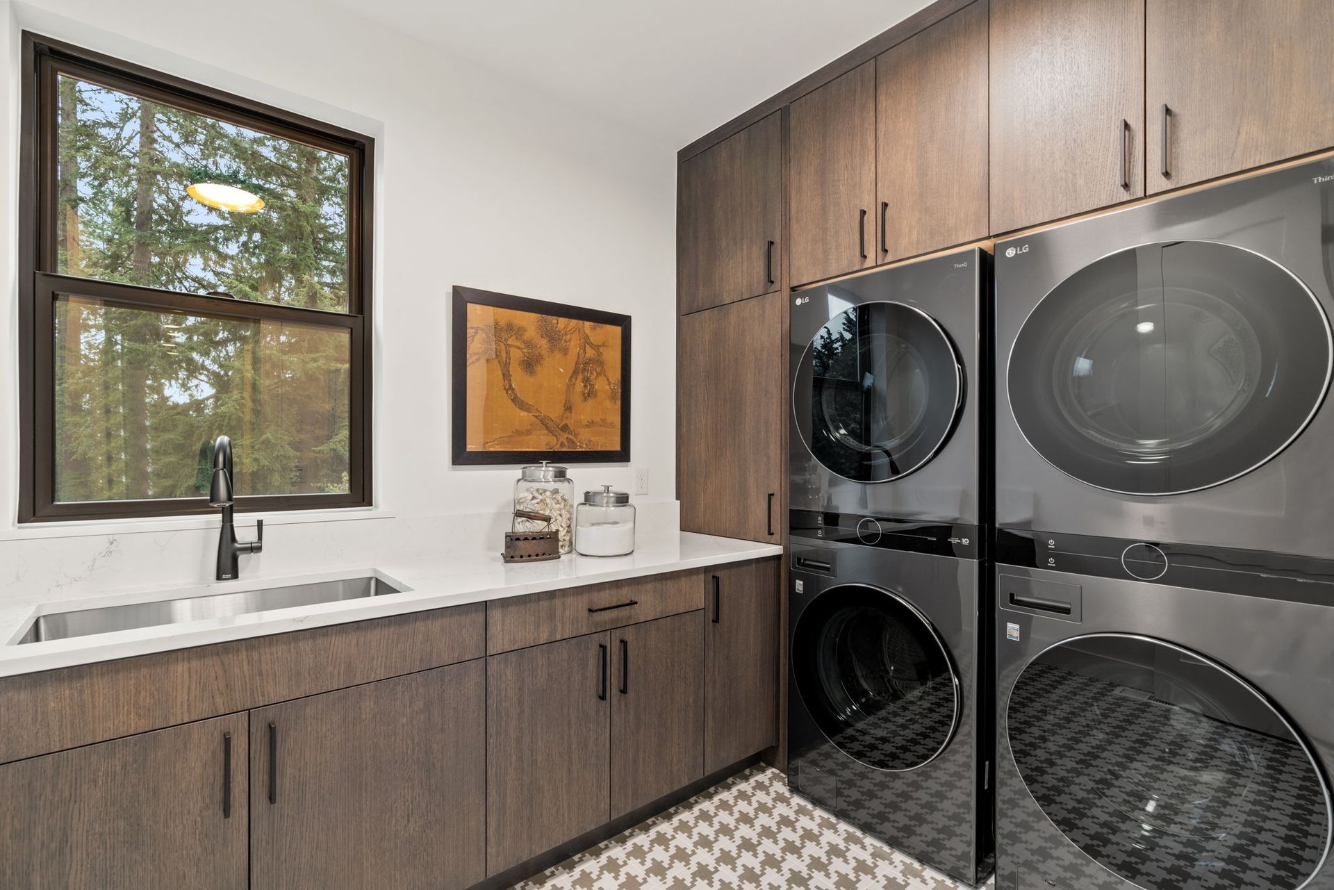 A laundry room with a washer and dryer stacked on top of each other.