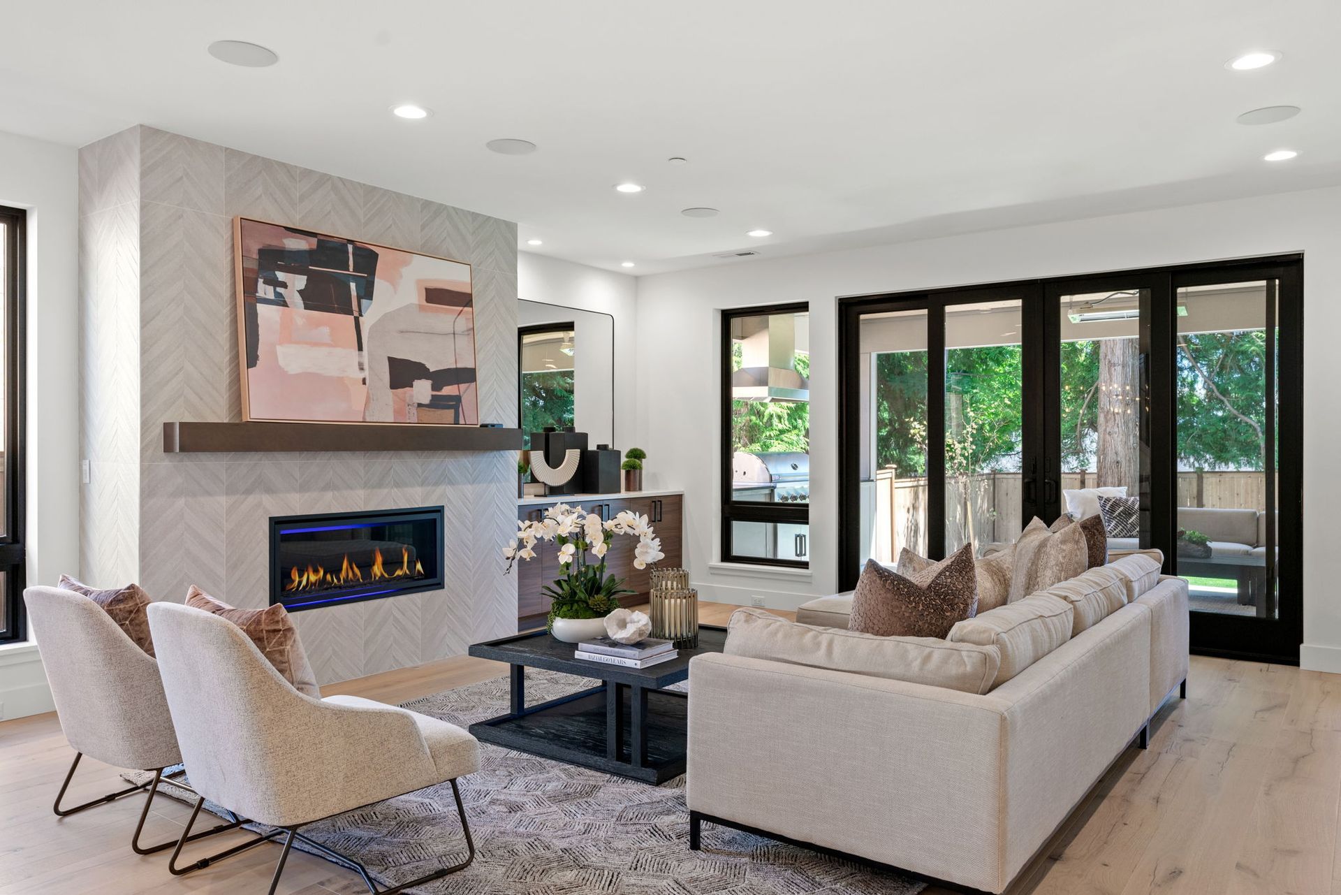 A living room with a couch , chairs and a fireplace.