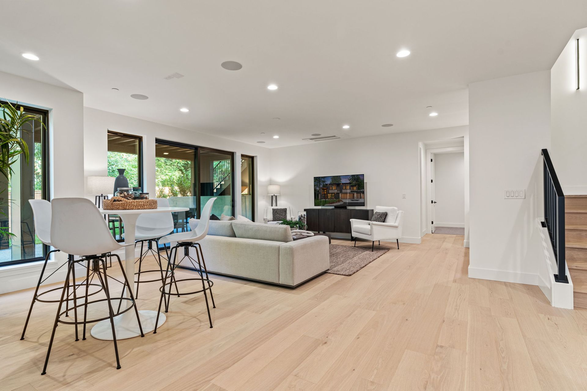A modern entryway with a white door, bench, built-in storage, and decor.
