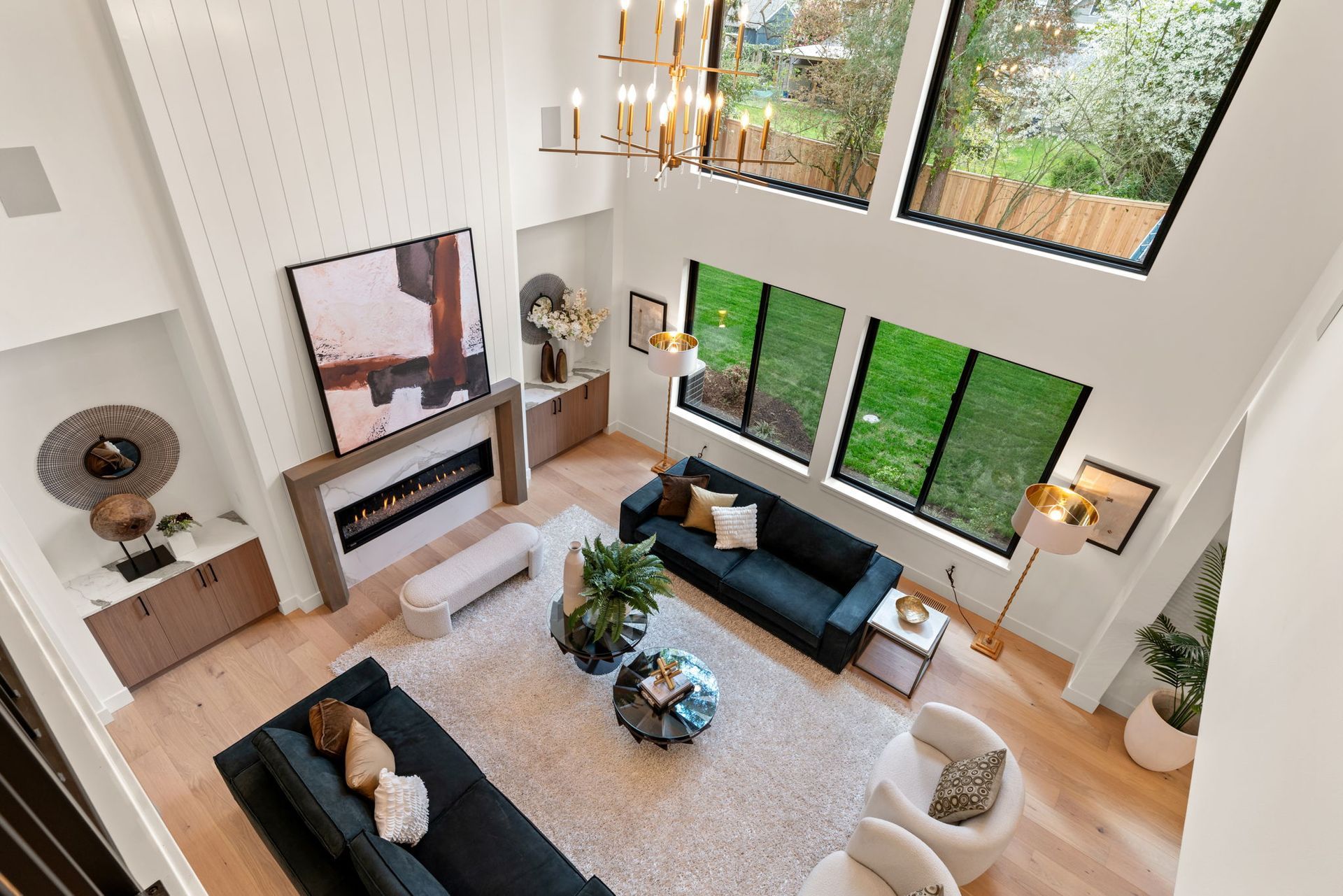 A spacious great room filled with furniture and a fireplace.