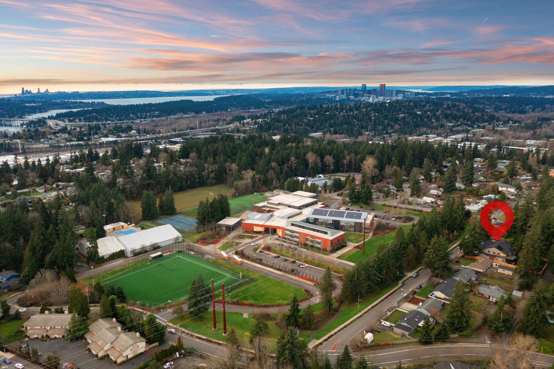 Bedroom interior with bed, seating area, large window, and walk-in closet.