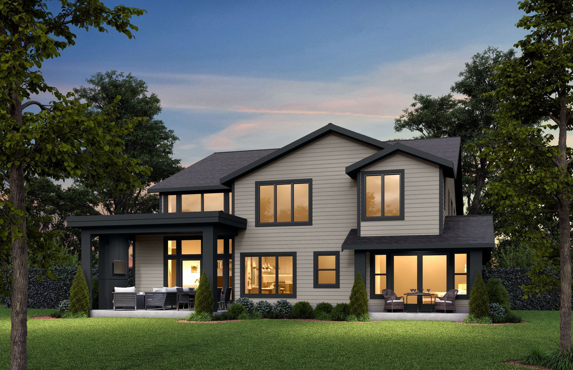 A large house with a lot of windows is surrounded by trees and grass.