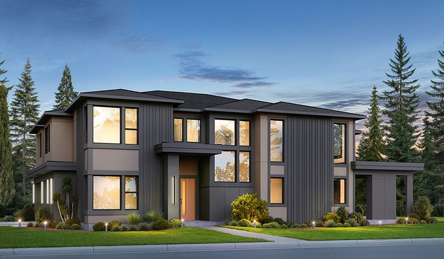 Modern two-story house with dark gray siding, large windows, and manicured lawn at dusk.