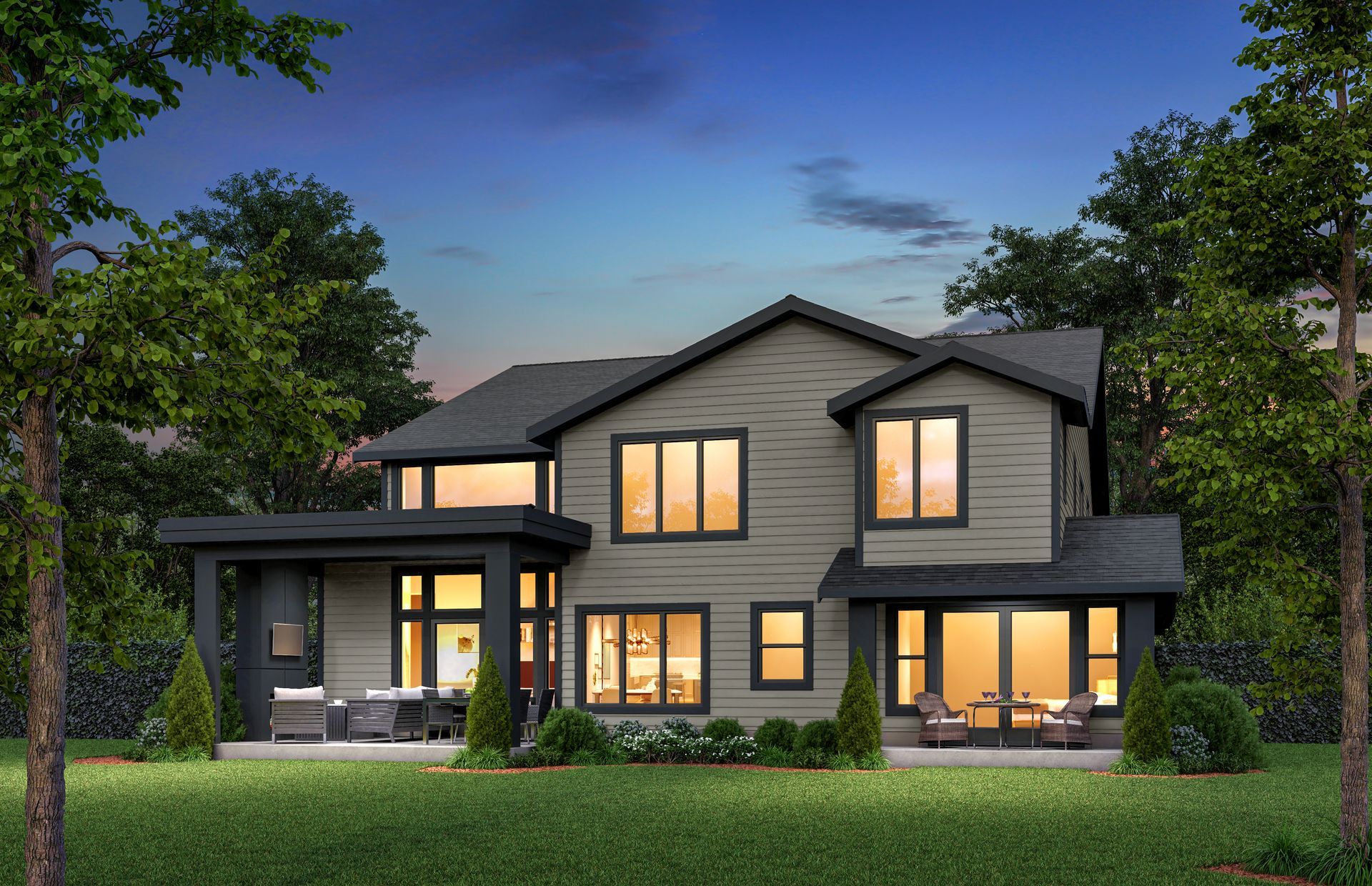 A large house with a lot of windows is surrounded by trees and grass.