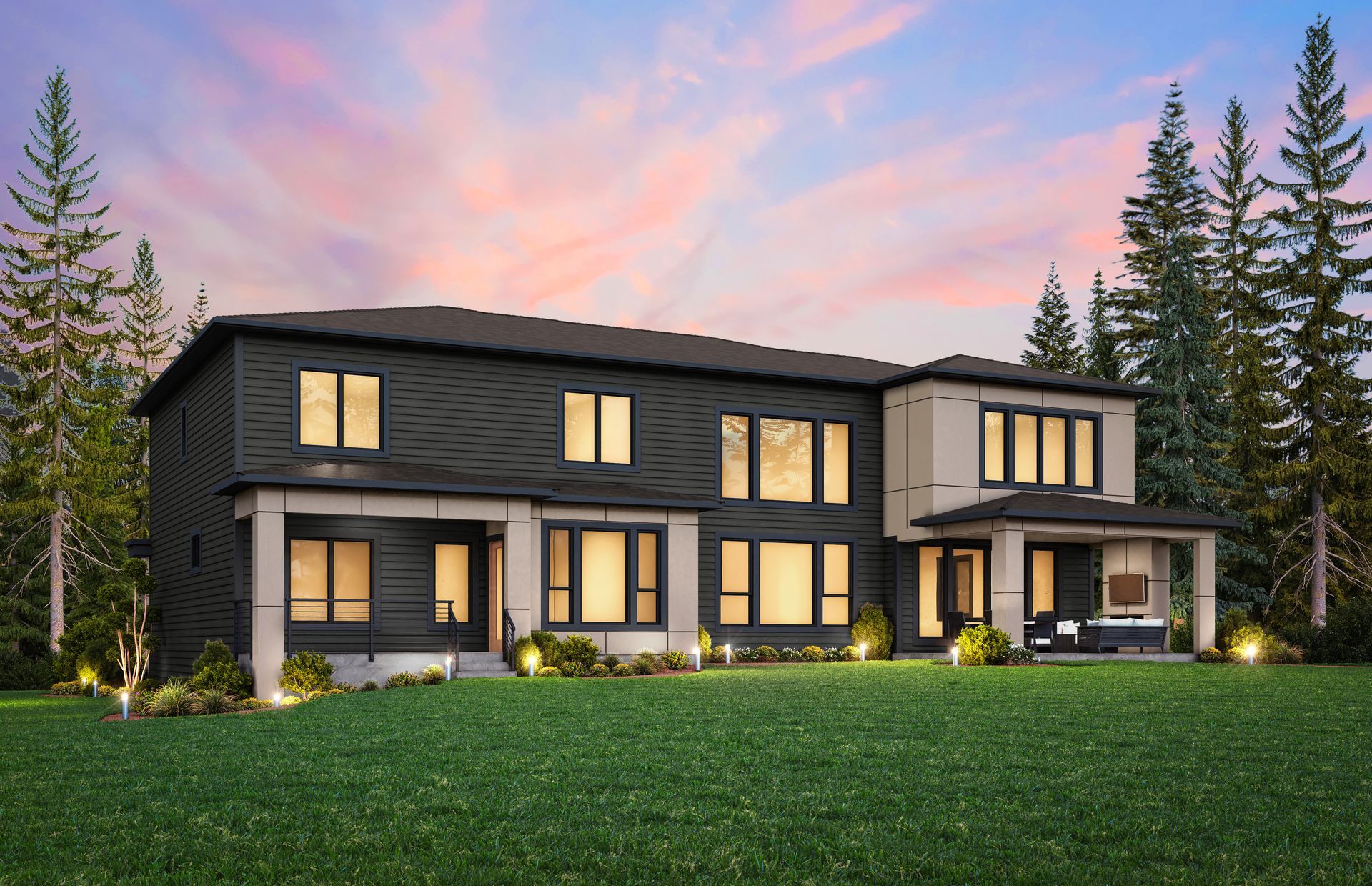 Modern two-story house with dark gray siding, tan accents, and a covered patio, set on a green lawn with trees.