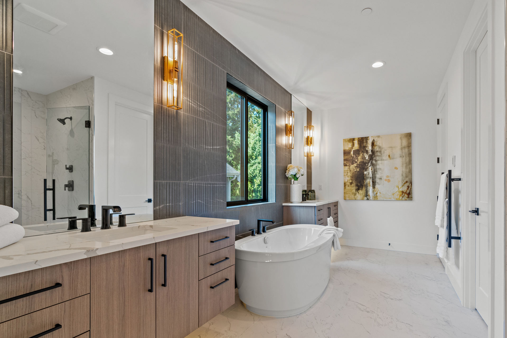 A bathroom with a tub , sink , and mirrors.