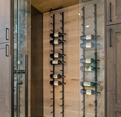 A row of wine bottles hanging on a wall in a wine cellar.