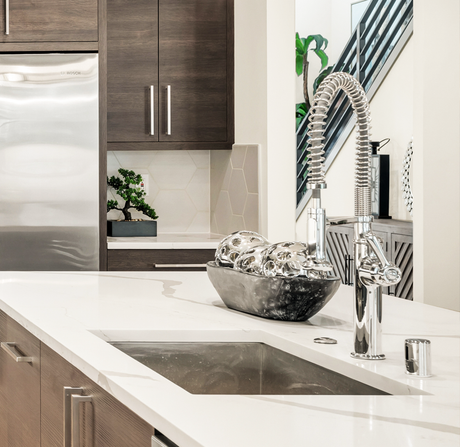A kitchen counter with a sink and a faucet