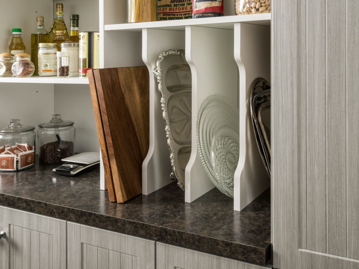 A kitchen pantry with a cutting board and a bowl on the counter.
