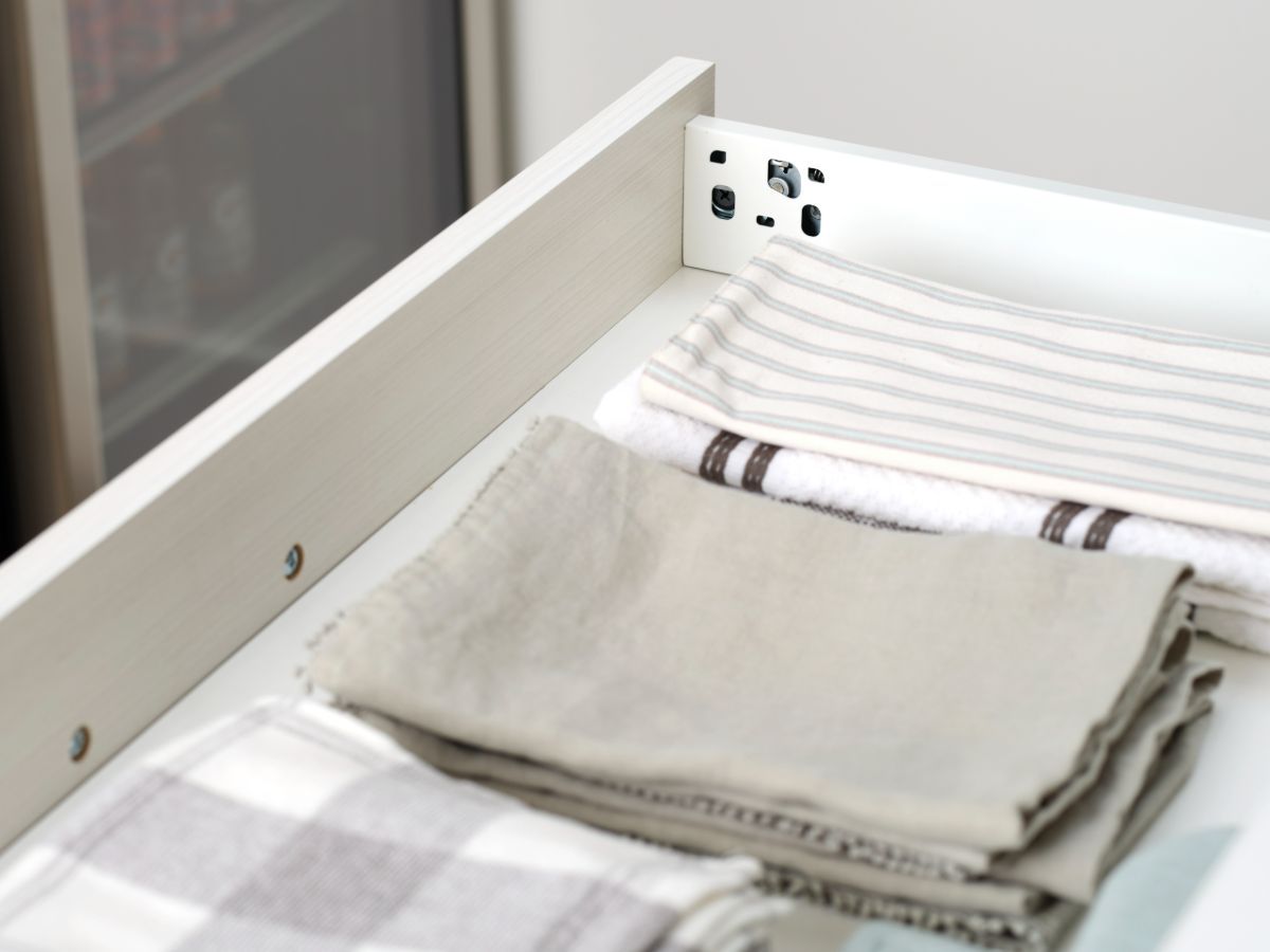 A bunch of towels are stacked on top of each other in a drawer