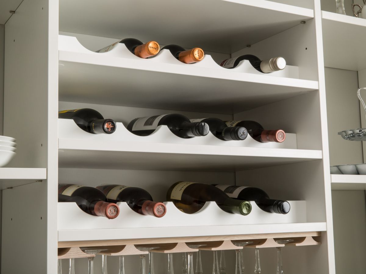 A wine rack with bottles and glasses on it
