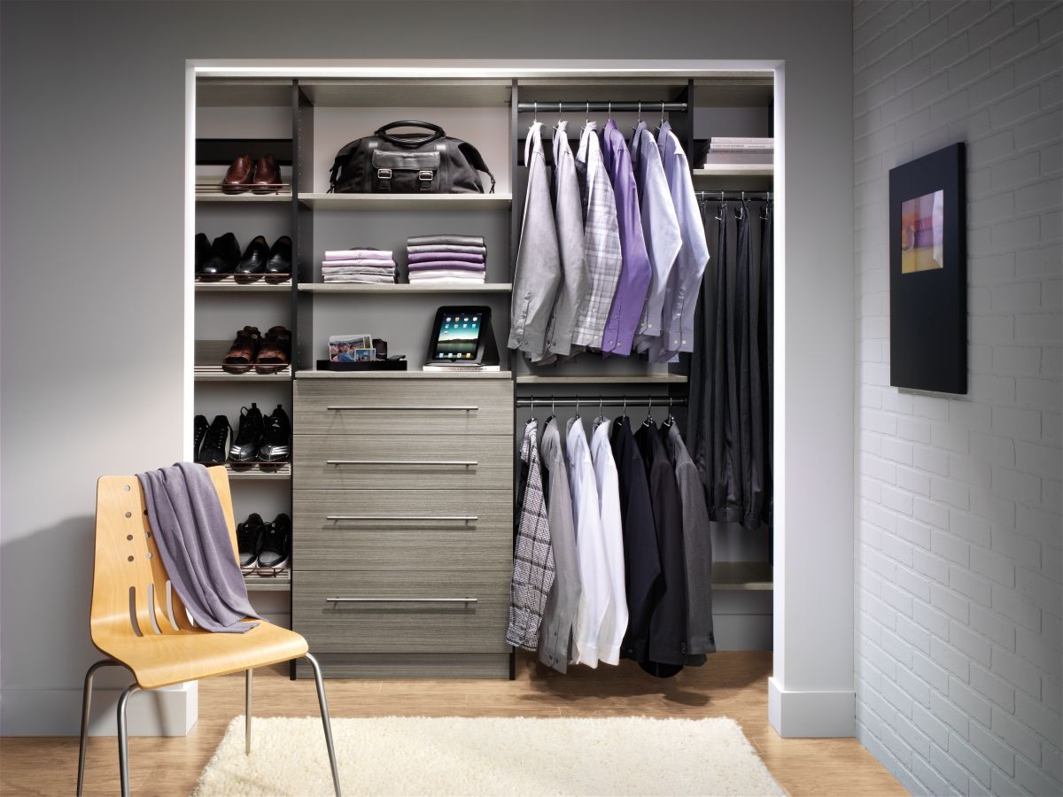 A closet filled with clothes and shoes and a chair