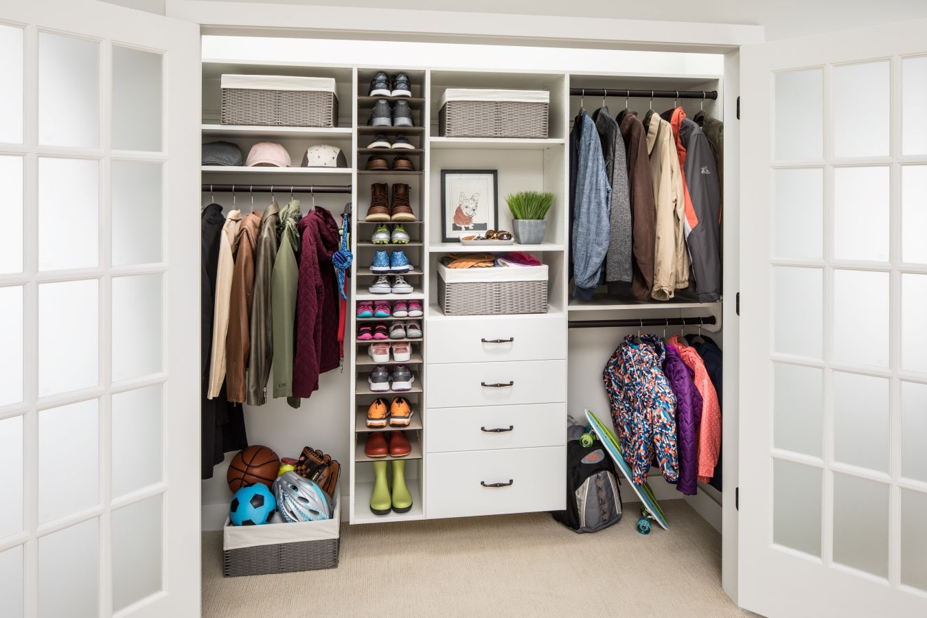 A closet filled with lots of clothes and shoes.
