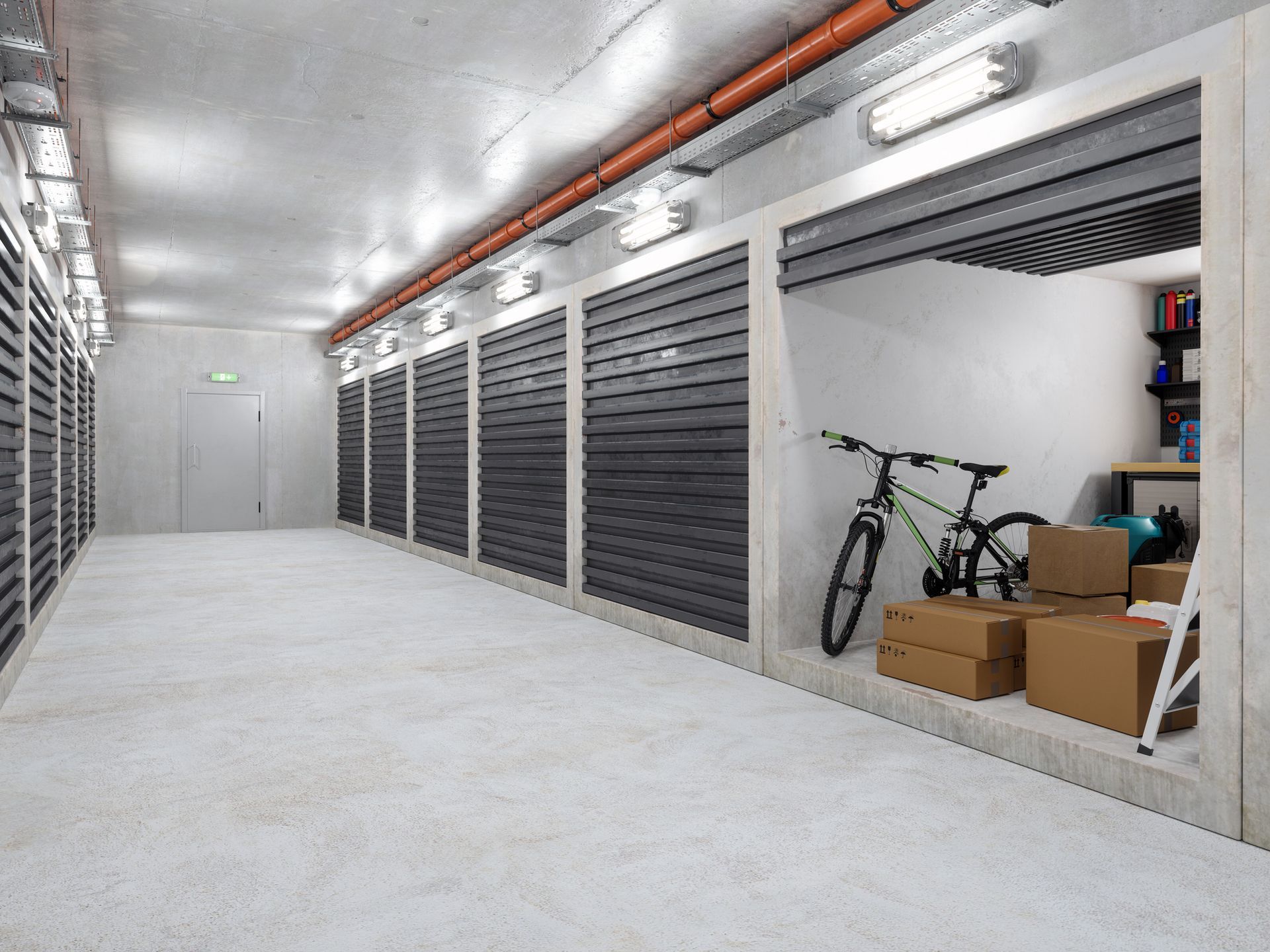 Open storage unit with bikes, boxes, and shelves in lit hallway.
