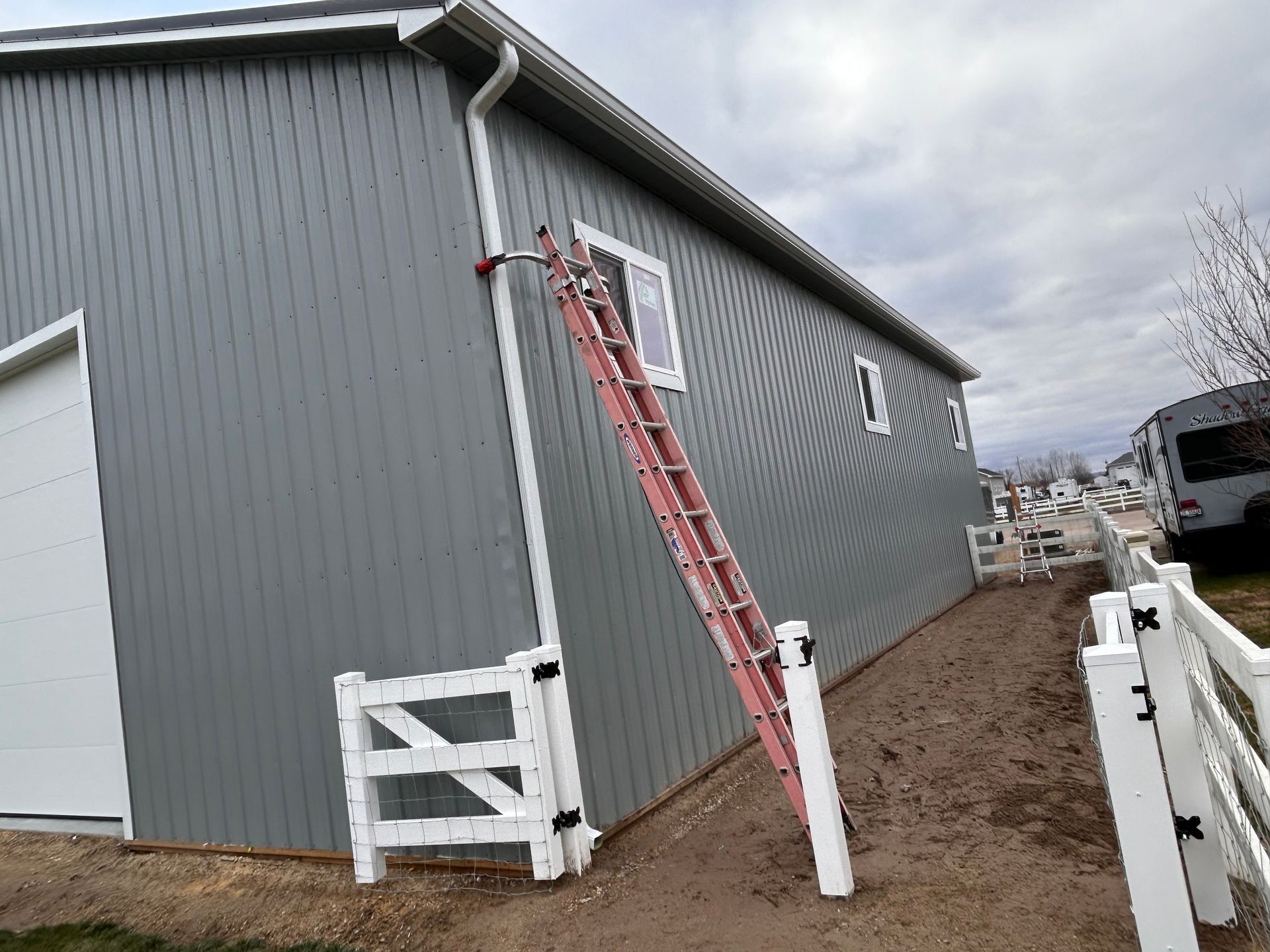 A ladder is leaning against the side of a building.