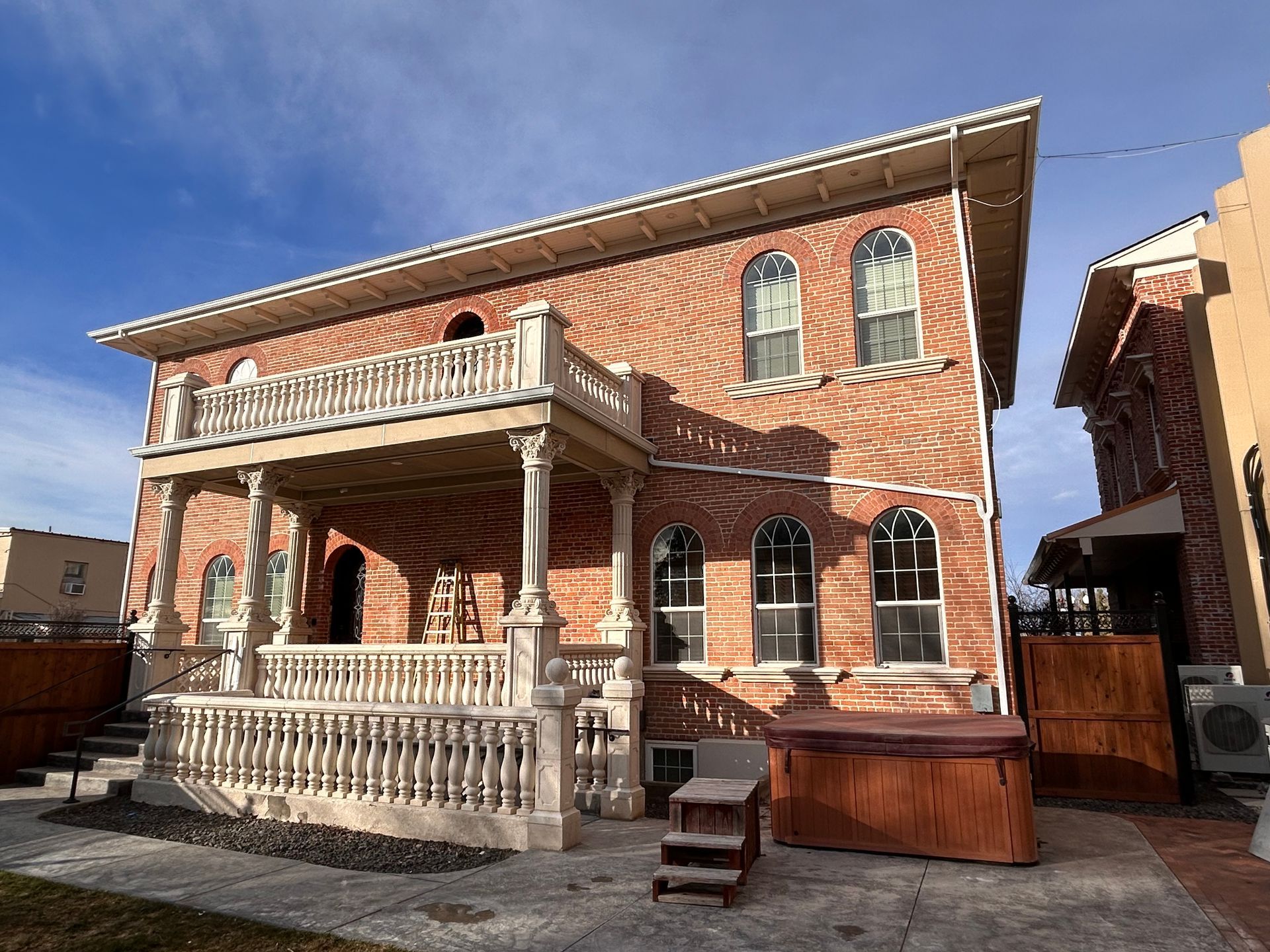 A large brick building with a hot tub in front of it