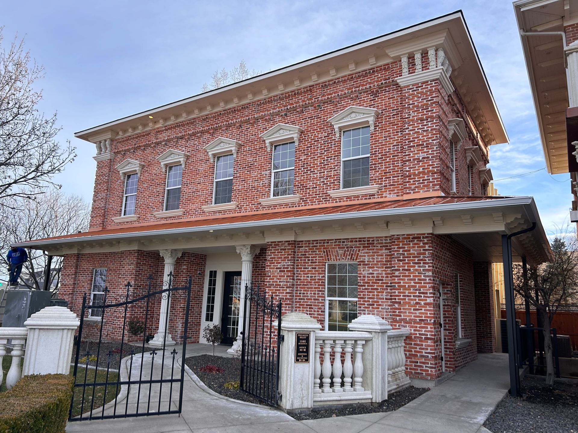 A large red brick house with a copper roof