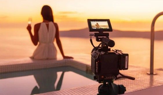 Photo of a female influencer enjoying sunset at a hotel pool.