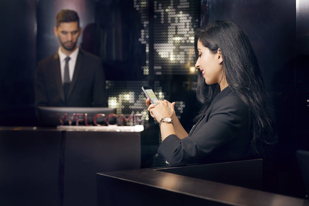 A woman using the hotel's guest messaging software