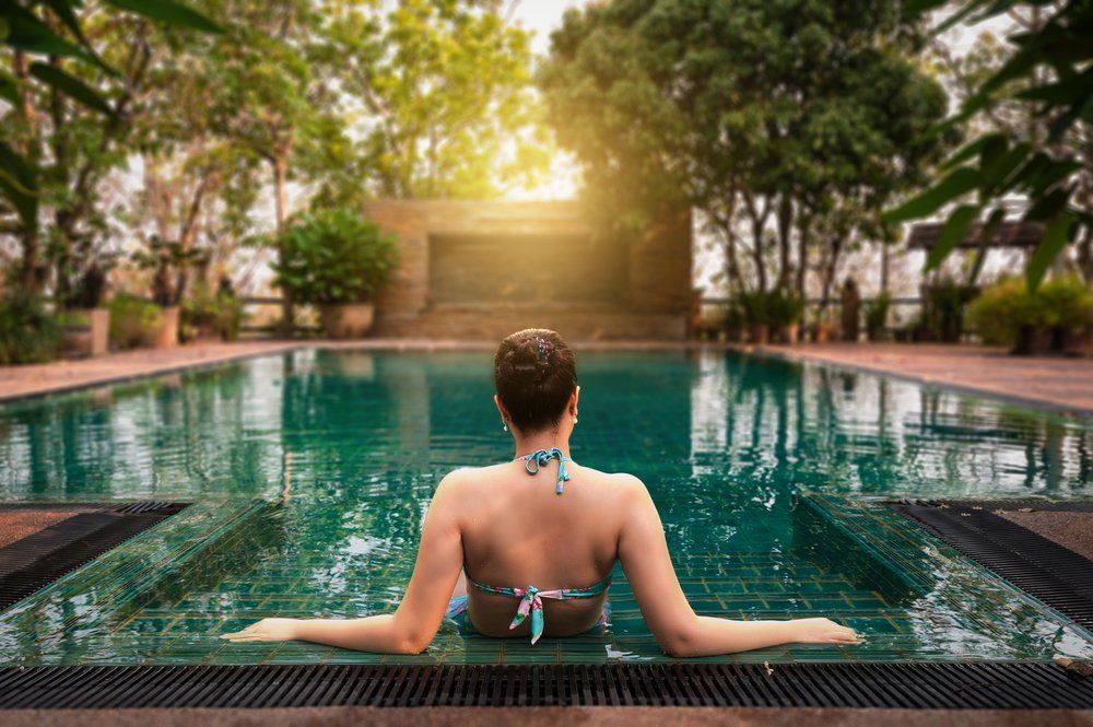 high quality image of a hotel guest enjoying an outdoor pool
