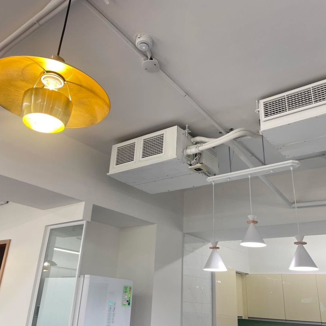 Ceiling with light fixtures, HVAC units, and a refrigerator.