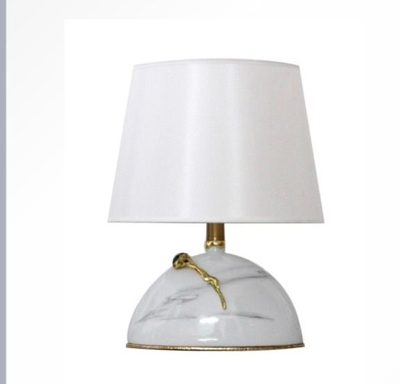 White marble table lamp with gold accents and white lampshade.