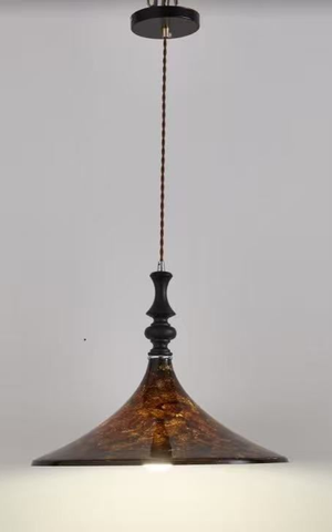 Brown and gold pendant light with a decorative, patterned shade, hanging from a ceiling.