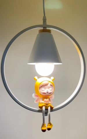 White pendant lamp with a cartoon character figurine hanging from a white ring.